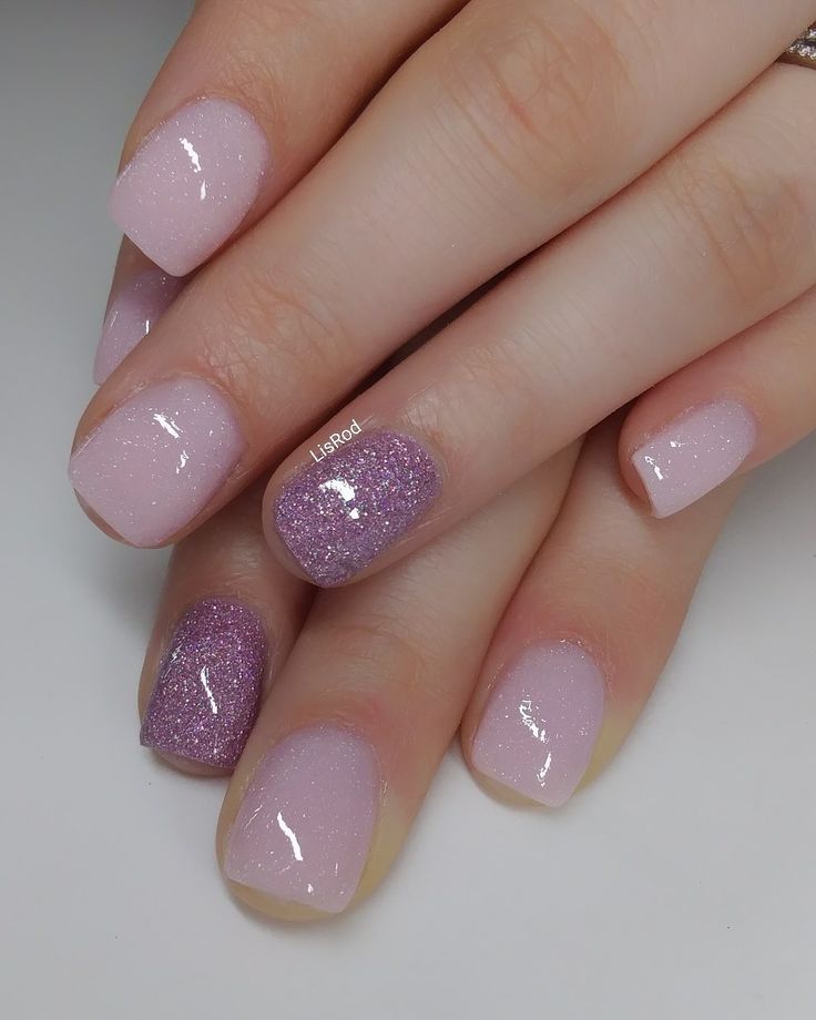 Elegant Soft Pink Nail Design with Shimmer and Purple Glitter Accents for a Glamorous Touch