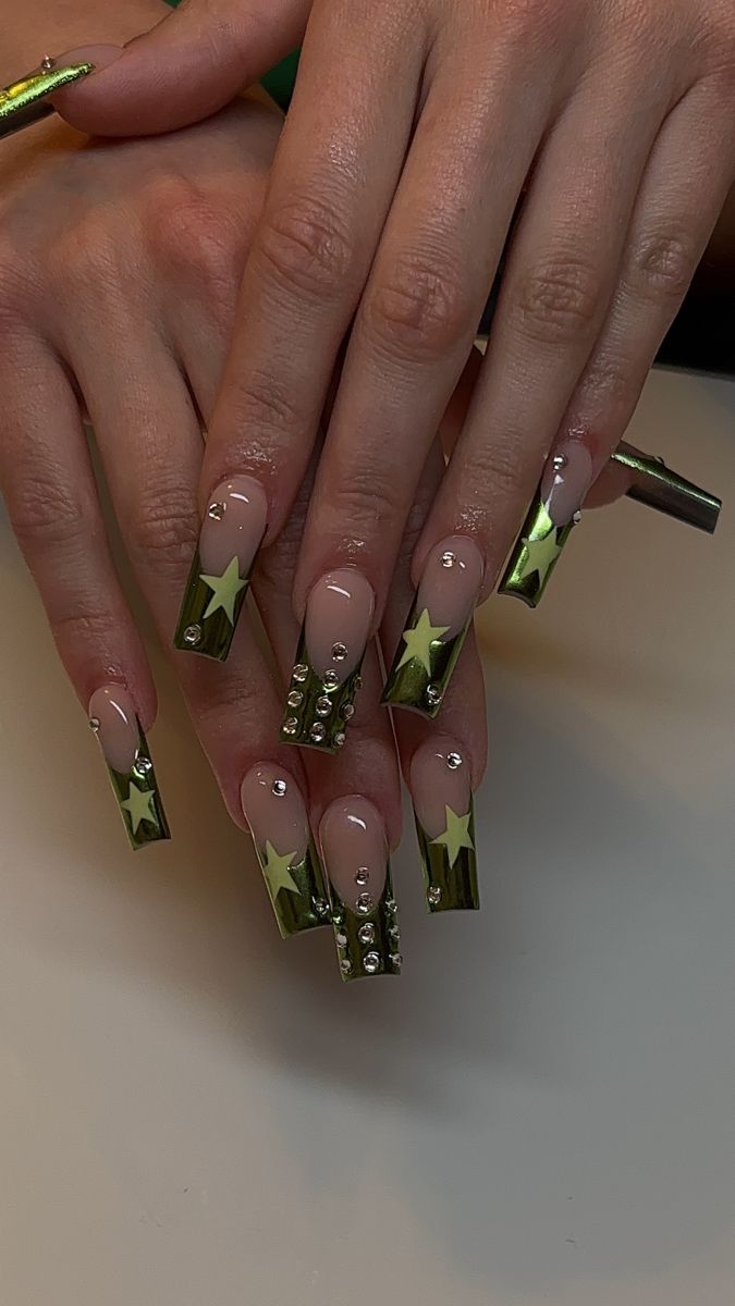 Glamorous Nail Design: Elongated Tips with Metallic Green Stars and Rhinestones.