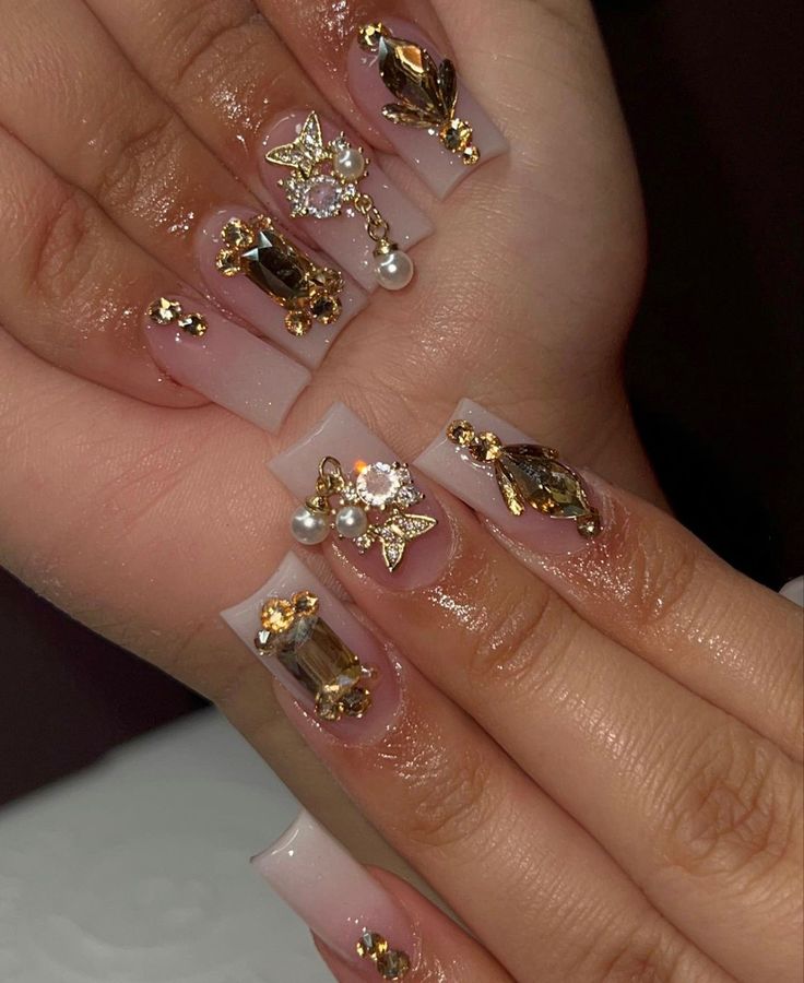 Sophisticated Nail Design Blending Natural Tones with Glamorous Gold and Crystal Accents.