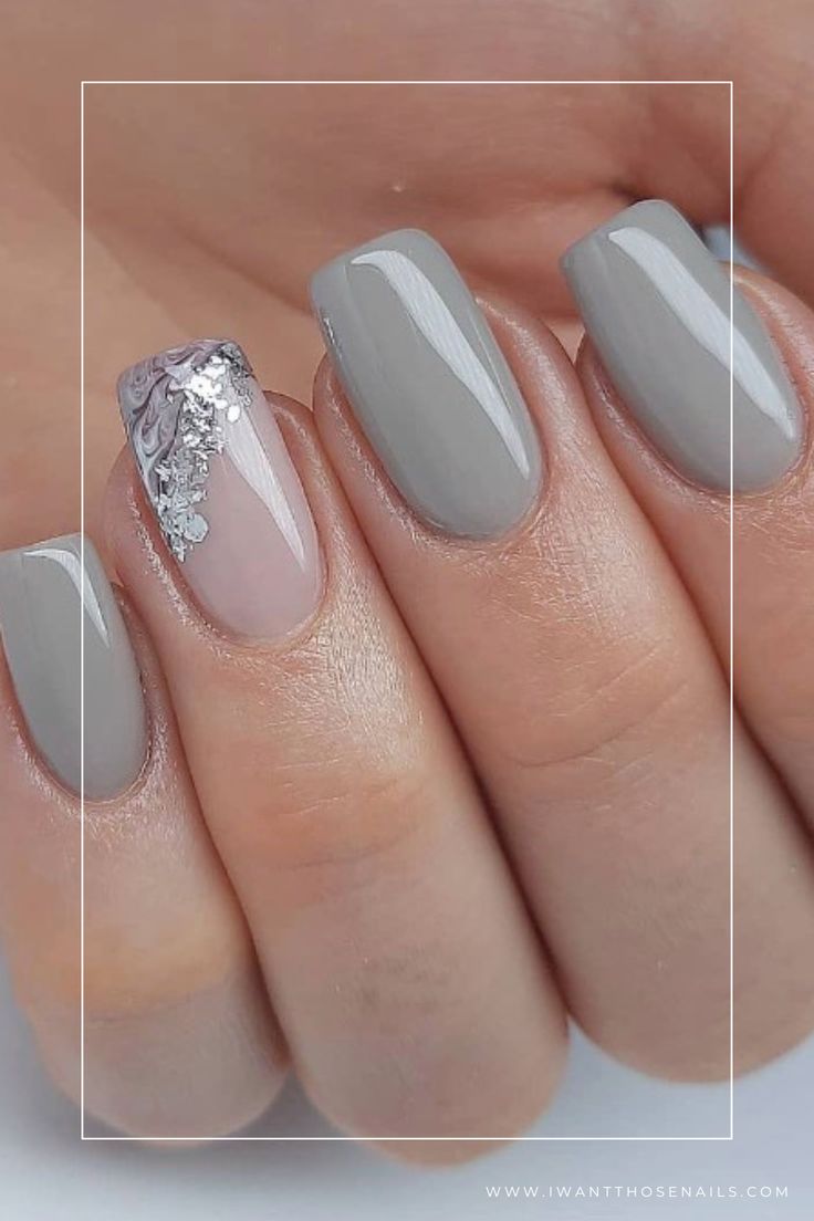 Elegant Gray Manicure: A Sophisticated Blend of Solid and Accent Designs with Sparkling Detailing.