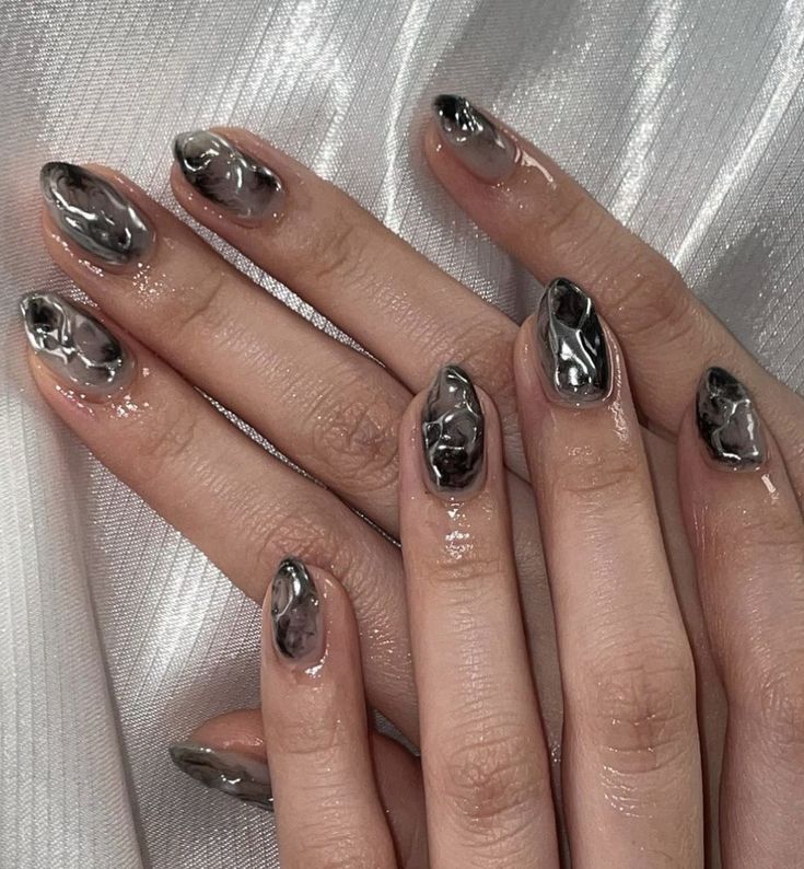 Sophisticated Glossy Black and Gray Marble Nail Design with Elegant Flowing Patterns.