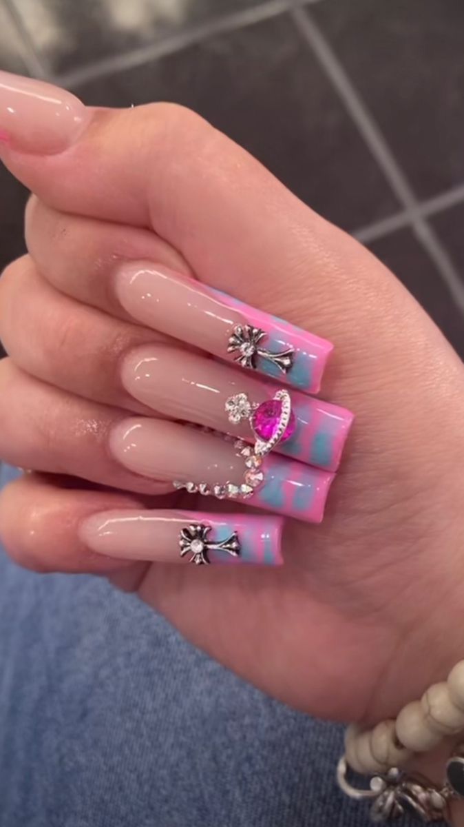 Playful Elegance: Pink and Blue Ombre Nail Art with Rhinestones and Floral Designs.