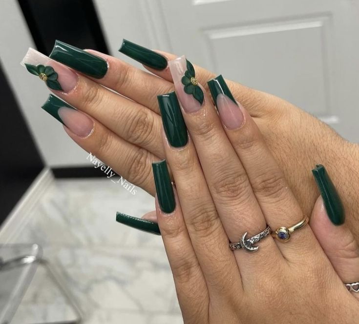 Elegant Dark Green Nail Design with Nude Accents and Leaf Embellishments.