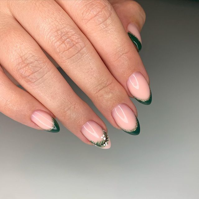 Sophisticated Almond-Shaped Nail Design with Soft Pink, Rich Green French Tips, Floral Accent, and Gold Accents.