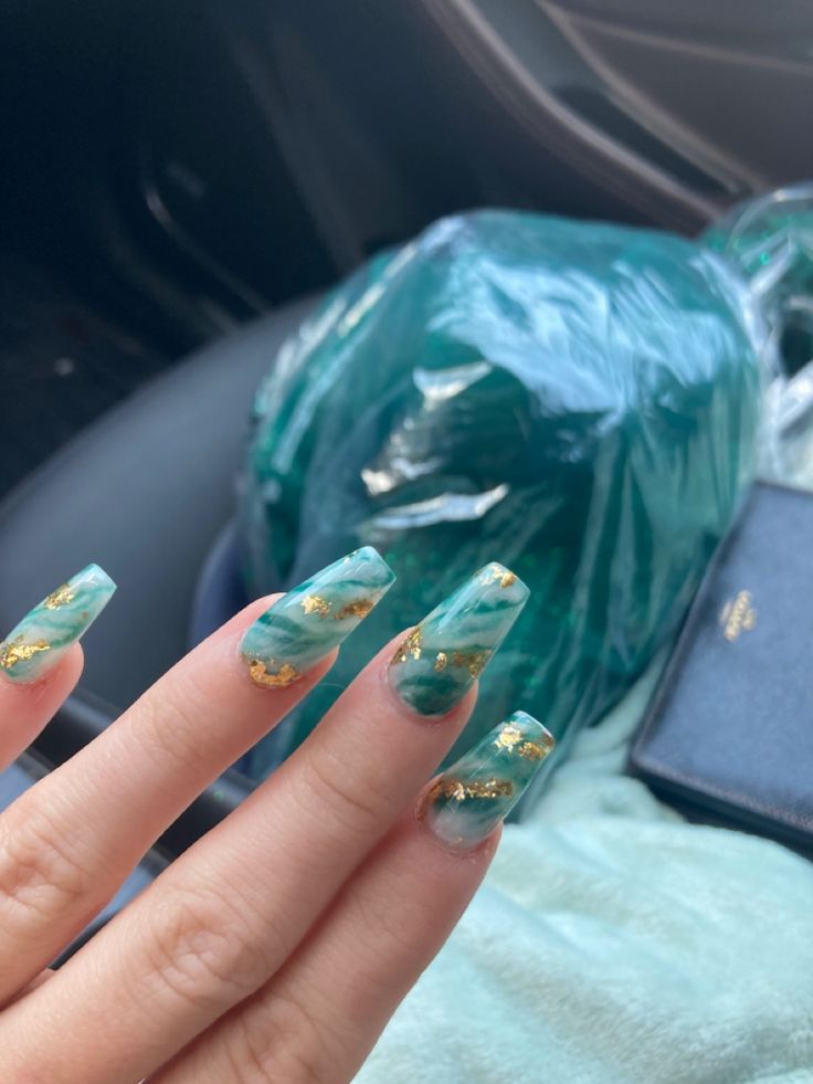 Elegant Marbled Teal Nail Design with Shimmering Gold Accents for a Striking Statement.