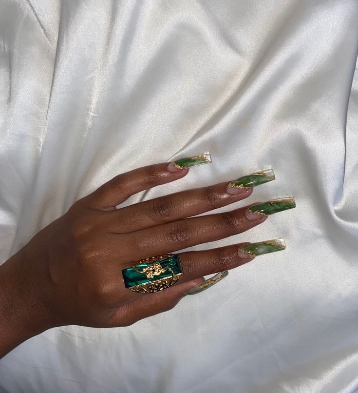 Chic Tapered Nail Design with Green and Gold Accents, Paired with a Turquoise Statement Ring