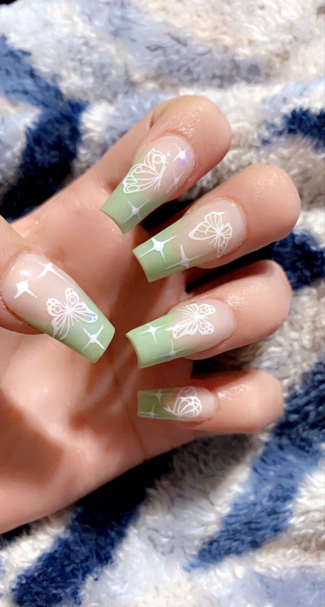 Whimsical Nature-Inspired Green Ombre Nail Design with Intricate Butterfly and Flower Patterns