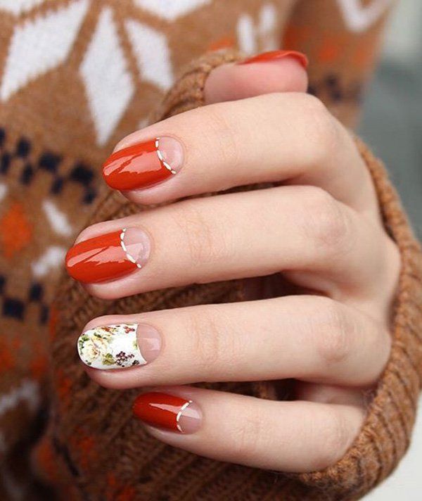 Charming Autumn-Inspired Nail Design with Rich Orange, Floral Accents, and Elegant Gold Lines.