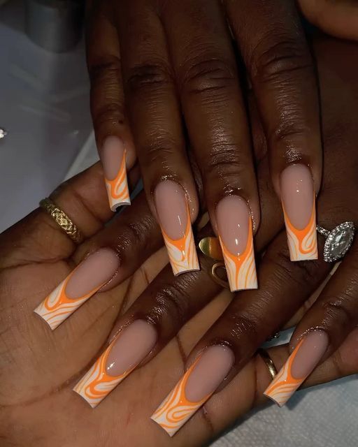 Vibrant Orange and Nude Swirl Nail Design with Elegant Elongated Tips.