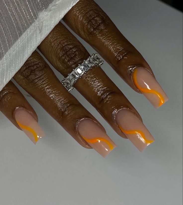 Chic Nail Design with Glossy Natural Base and Bold Orange Swirls, Complemented by Elegant Jewelry.