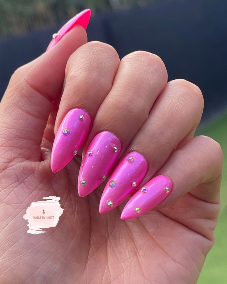 Glamorous Bold Pink Nail Design with Glossy Gradient and Rhinestones.