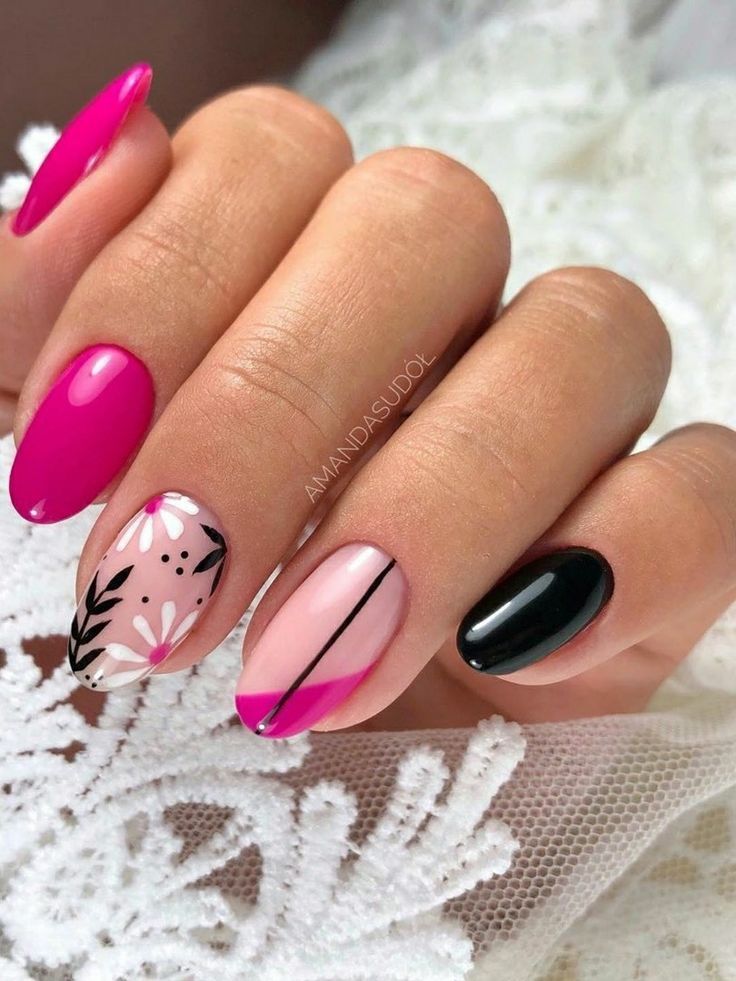 Vibrant Pink and Black Nail Design with Floral Patterns and Glossy Finishes.