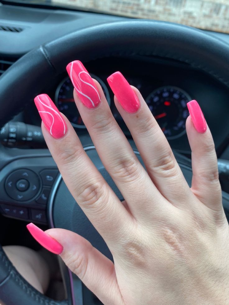 Playful Pink Nails with Glossy Finish and Artistic White Accents.