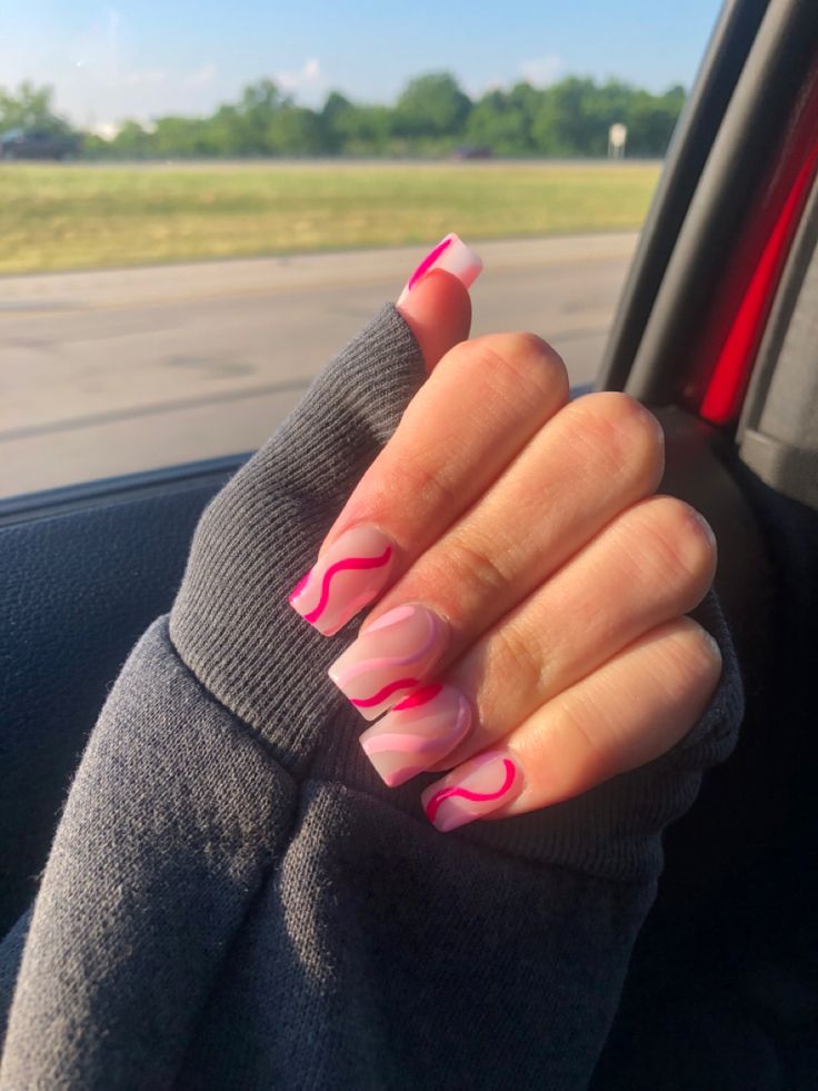 Chic Nail Art: Soft Pink Base with Playful Vibrant Pink Wavy Lines for a Modern Look.