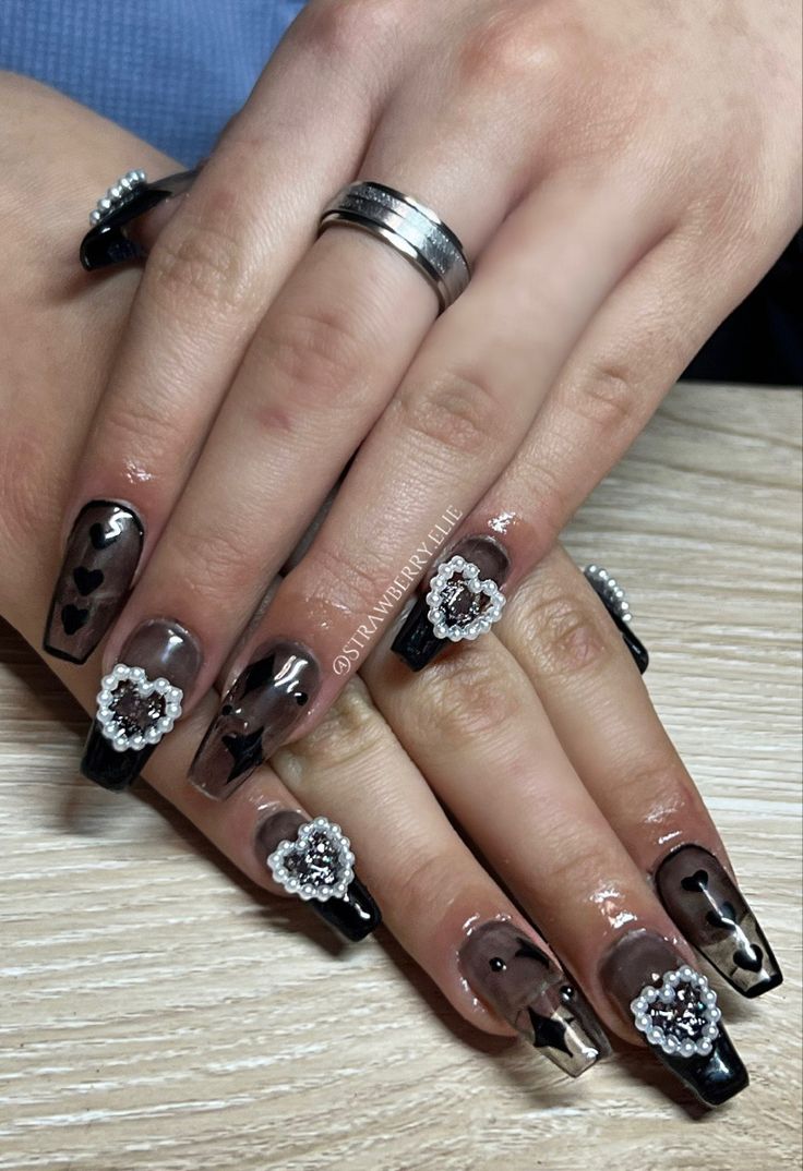 Elegant Black and Clear Nail Design with Intricate Details and Glamorous Accents