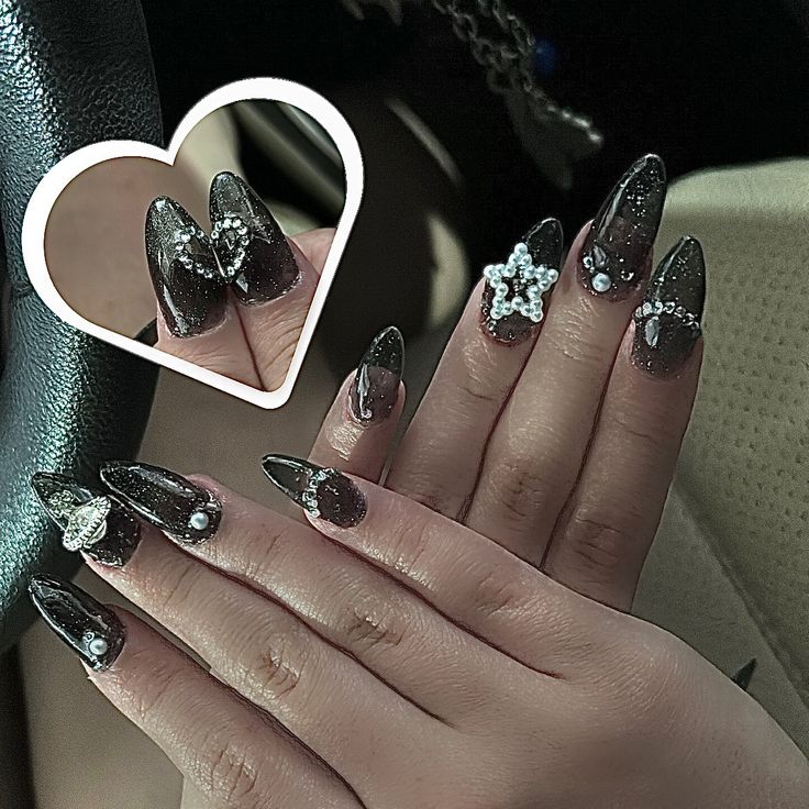 Luxurious Black Polished Nails Embellished with 3D Gems for a Striking Look.