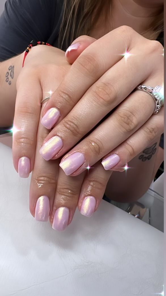 Chic Elegant Nail Design: Delicate Pink with Shimmery Iridescent Finish.