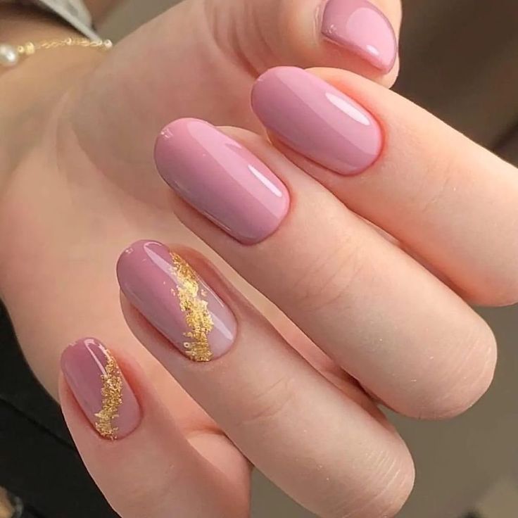 Sophisticated Soft Pink Nail Design with Glamorous Gold Accents.