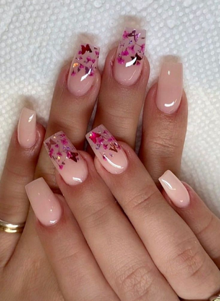 Chic Nail Design: Soft Nudes with Glitter Accents and Playful Flakes.