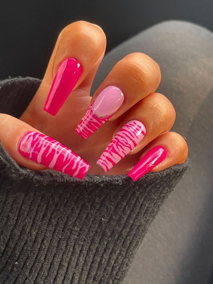 Vibrant Nail Design: Bold Pink Hues and Playful Patterns for a Striking Statement.