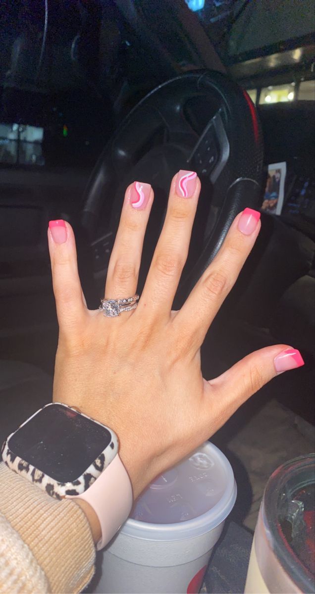 Chic Bright Pink French Tip Manicure with Whimsical White Swirls for a Playful and Feminine Look.