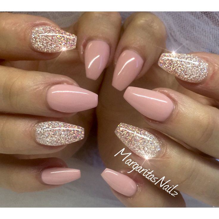 Sophisticated Glossy Nude Nail Design with Glitter Accents on Almond-Shaped Nails.