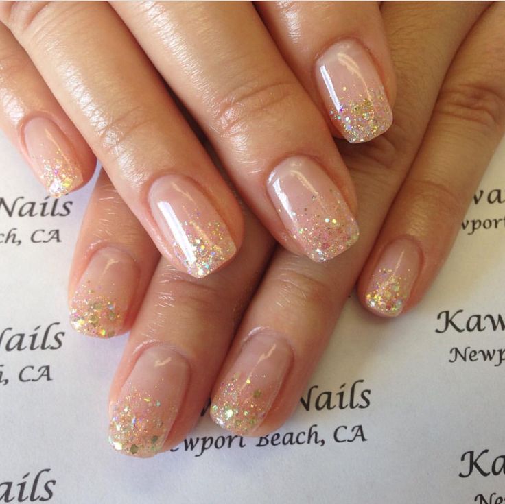 Chic Ombre Nail Design: Elegant Nude Base with Shimmering Glitter Tips.