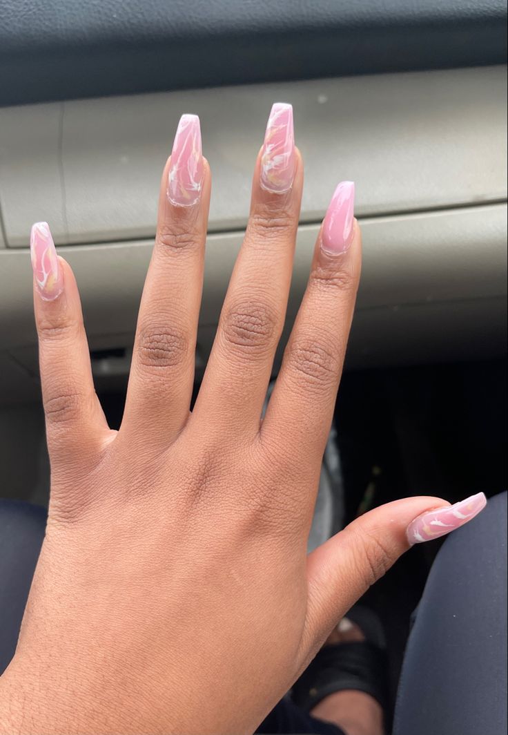 Sophisticated Long Pink Acrylic Nails with Elegant Marble Design.