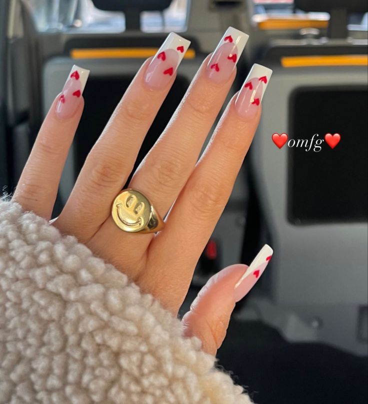 Chic French Tip Nail Design with Playful Red Hearts and Minimalistic Accents.