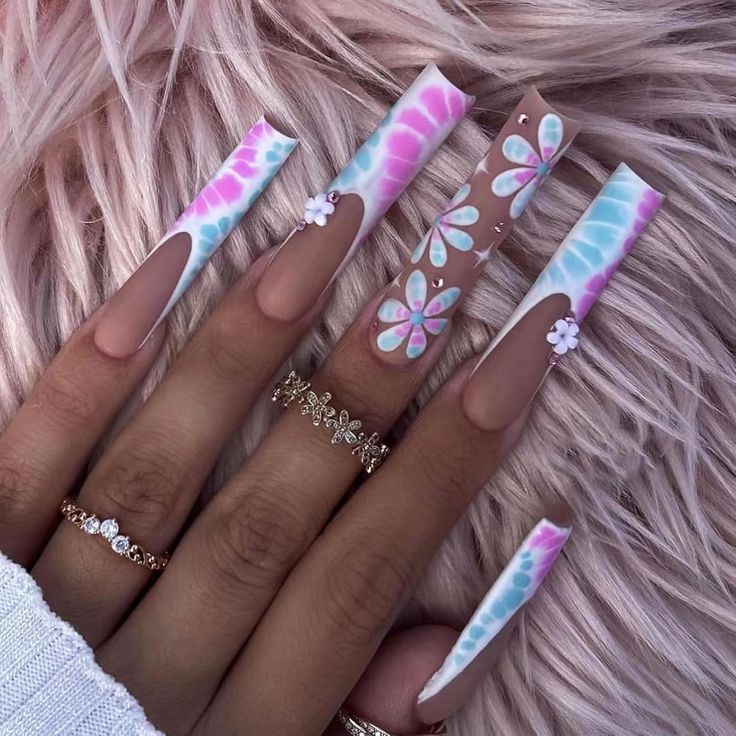 Playful Pastel Nail Design with Floral Accents and Chic Embellishments.