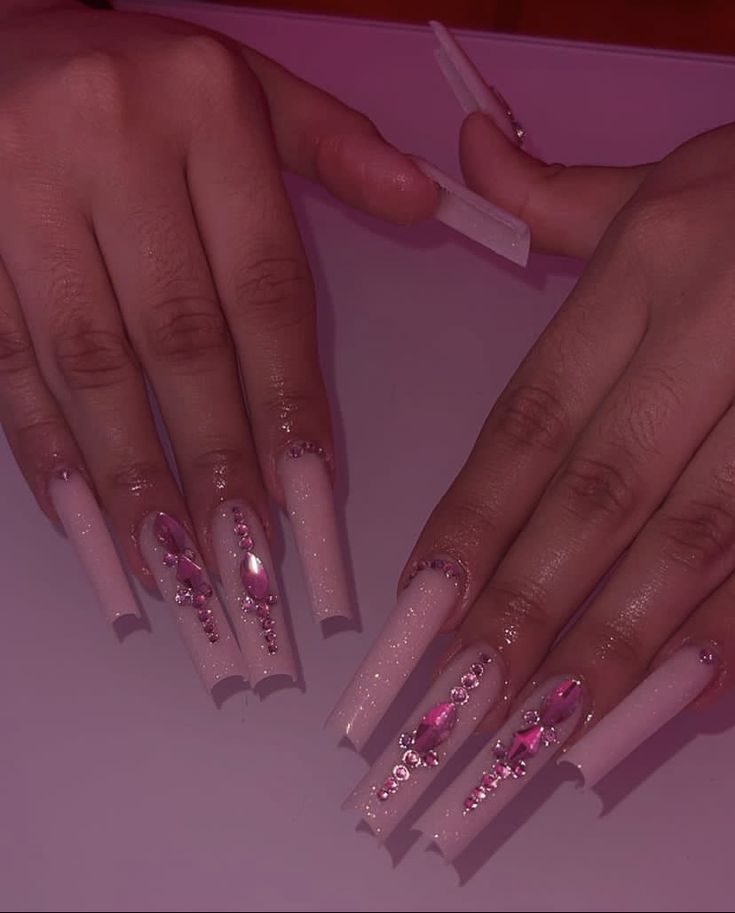 Glamorous Long Nails: Elegant Soft Pink Base with Stunning Accents and Jewels for Any Occasion.