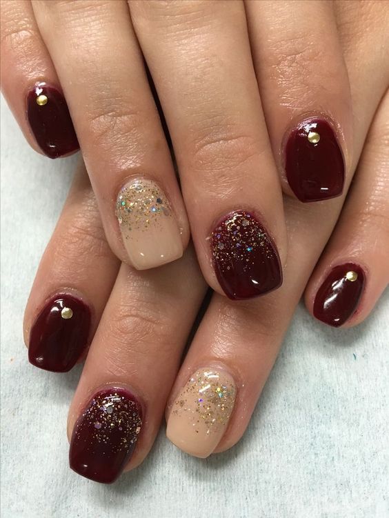 Chic Burgundy and Sparkling Nude Nails with Gold Accents for Elegant Glamour.