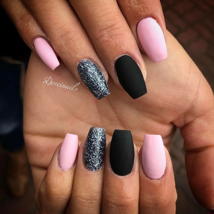 Chic Matte Black and Soft Pink Nail Design with Glitter Accents for a Sophisticated Look.