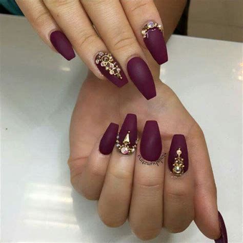 Sophisticated Burgundy Matte Nails with Intricate Embellishments for Chic Elegance.