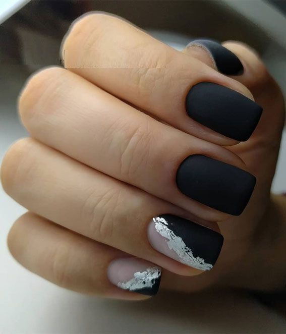 Chic Matte Black and Beige Nail Design with Glamorous Silver Flakes.