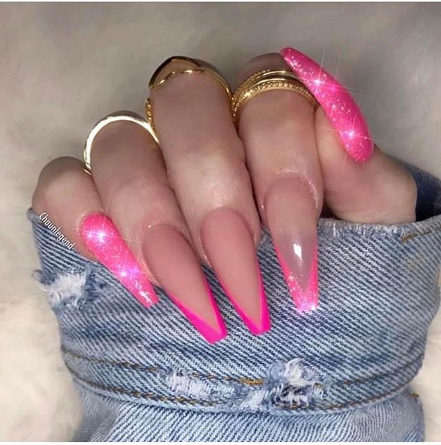 Chic Stiletto Nail Design: Nude Ombre with Glittery Pink Tips & Elegant Gold Accents.