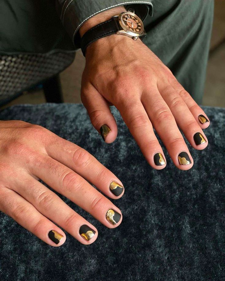 Bold Artistic Nail Design with Modern Black, Gold, and Nude Palette