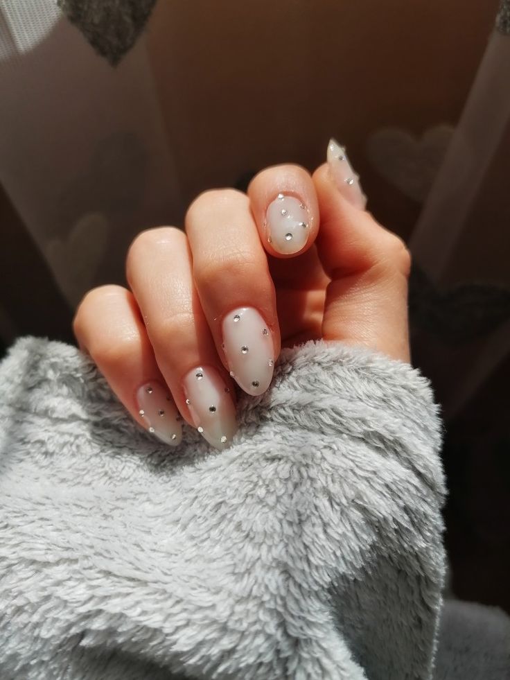 Elegant Sheer Nail Design with Silver Accents for a Chic Look.