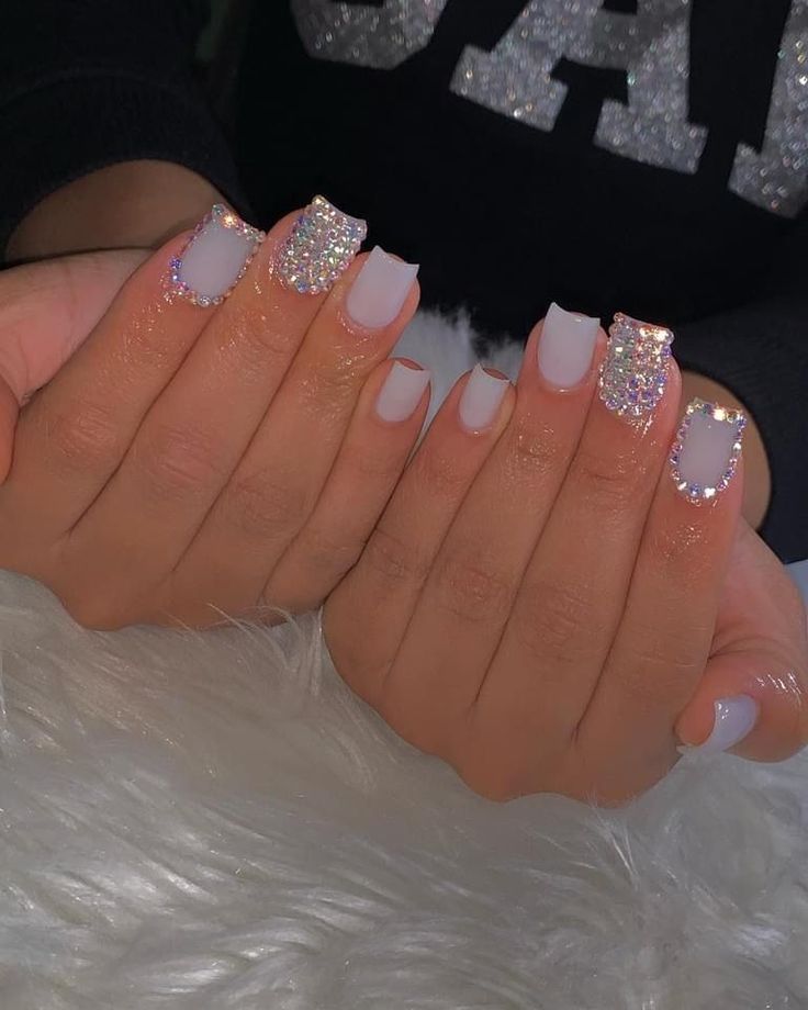 Chic Glittery Nail Design: A Matte-Gloss Elegance with Pastel Base and Gem Accents.