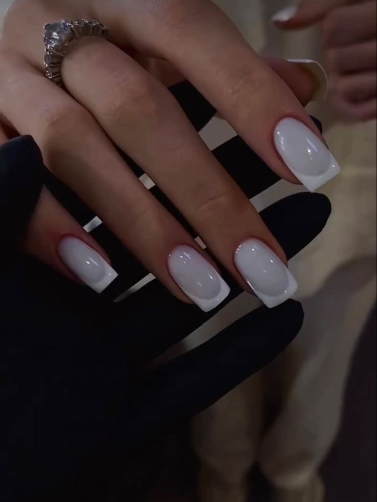 Sophisticated French Manicure with Glossy White Finish and Subtle Red Accents.