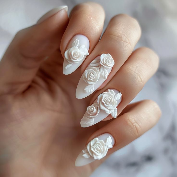 Elegant Three-Dimensional White Floral Nail Design with Matte Finish.