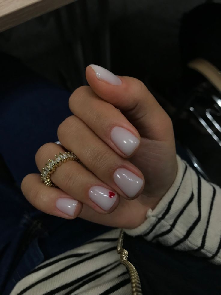 Chic Pale Pink Manicure with Whimsical Red Heart Accent