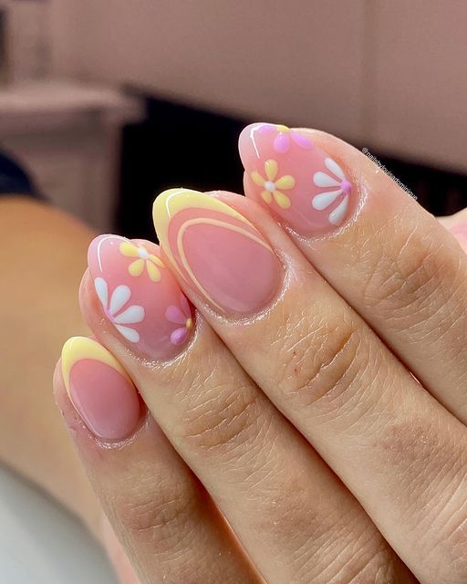 Cheerful Almond-Shaped Nails: Soft Pink Base with Yellow Tips and Pastel Floral Designs for a Fresh Spring Look.