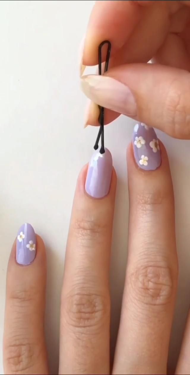 Charming Lavender Nail Design with Delicate White Floral Accents for Spring/Summer.