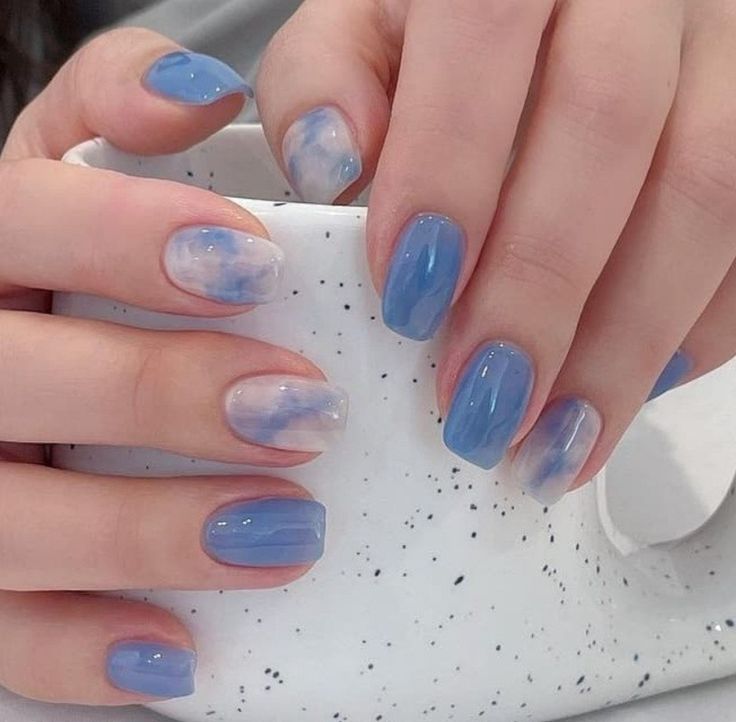 Ethereal Sky-Inspired Nail Design with Gradient Blues and Cloud Accents.