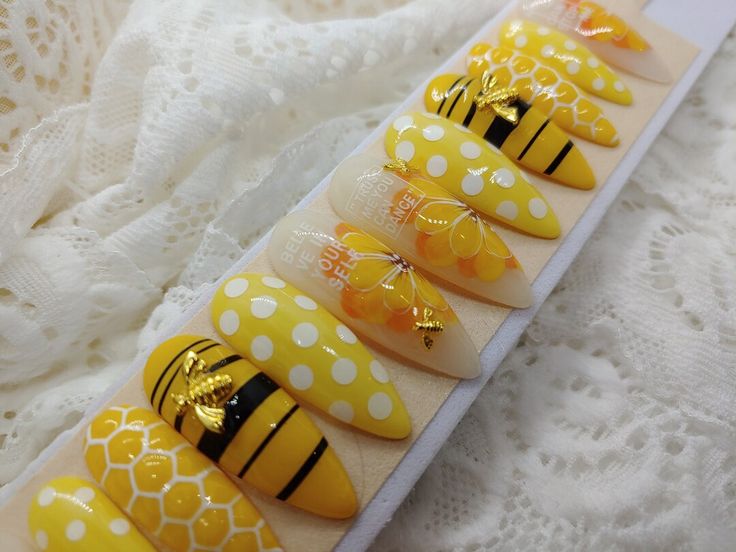 Vibrant Bee-Themed Nail Design with Playful Polka Dots and Intricate Honeycomb Patterns.