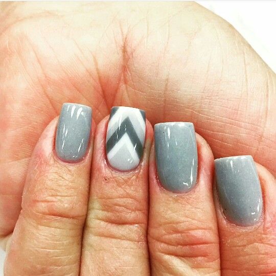 Chic Gray Nail Design with Solid Colors and Chevron Pattern for a Modern Manicure.