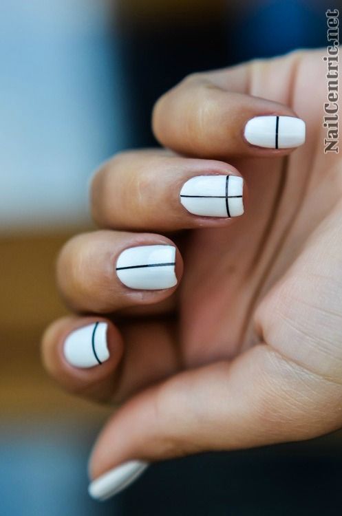 Elegant Minimalist Chic Nail Design with White Base and Black Geometric Lines.