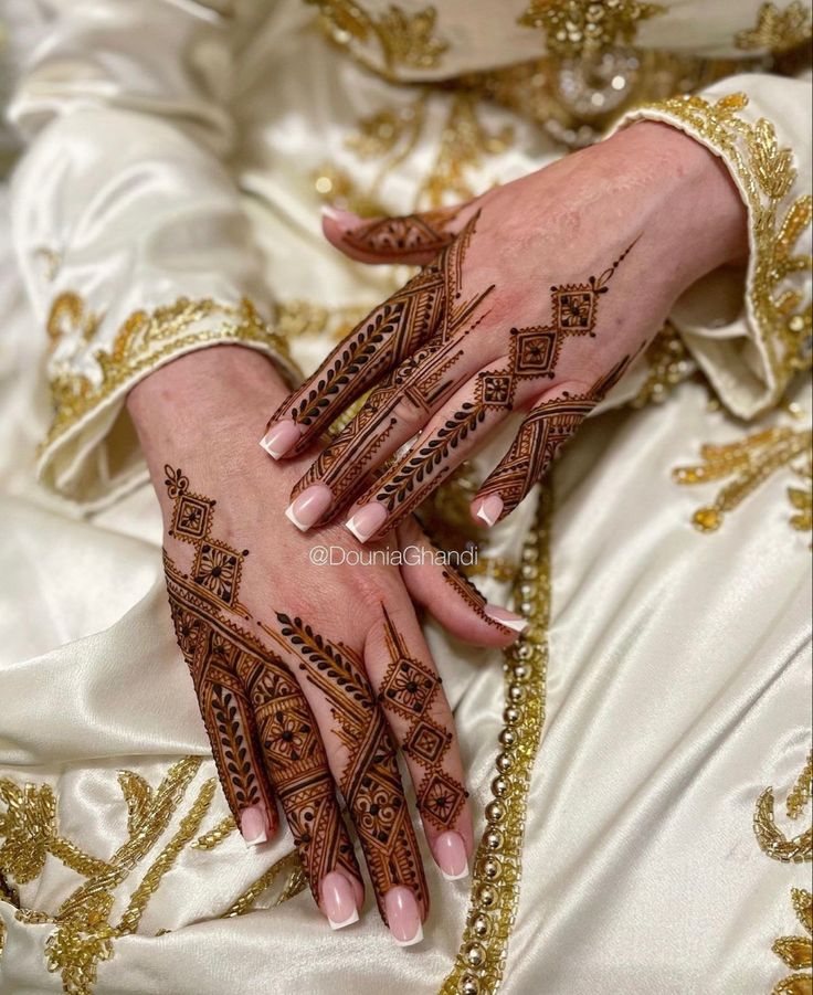 Intricate Henna Hand Design Enhanced by Elegant Nails and Luxurious Attire.