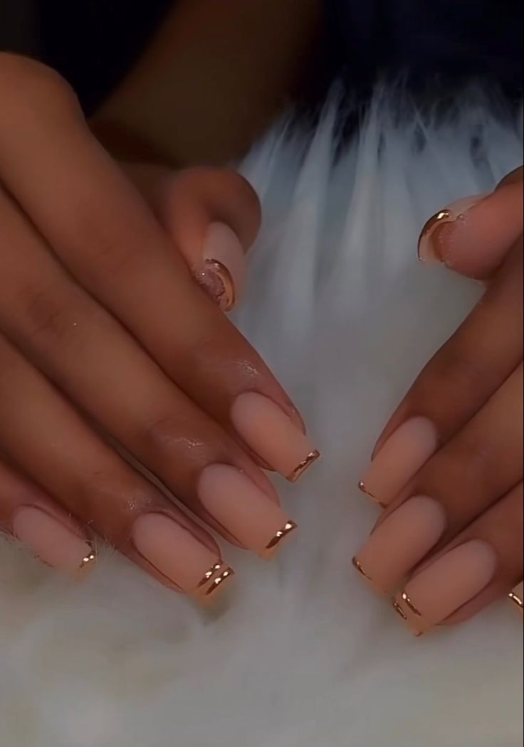 Chic Nude Matte Nails with Stylish Gold Tips for a Sophisticated Look.